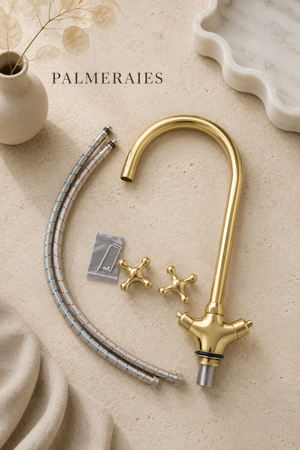 Handmade unlacquered brass bridge kitchen faucet with dual cross handles, braided supply hoses, installation hardware, and accessories displayed on a neutral background.