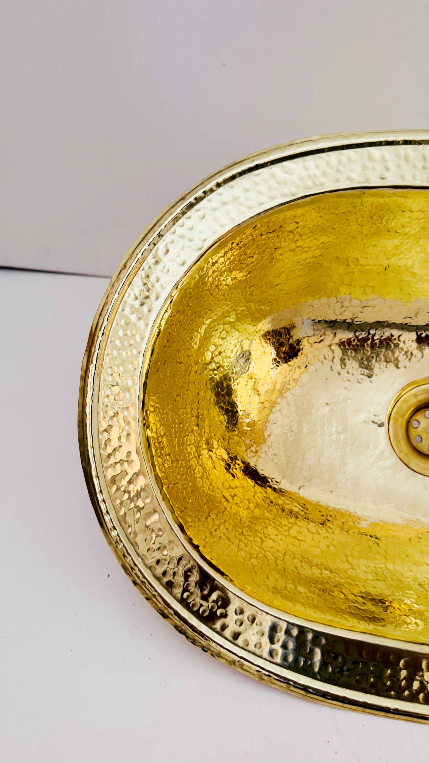 a gold colored bowl with a white background