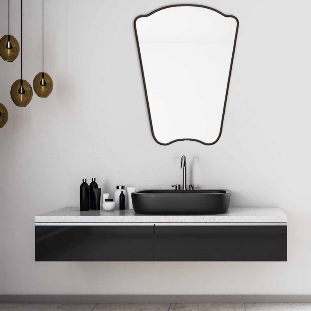 black Irregular Mirror hanging on bathroom , brass faucet and sink