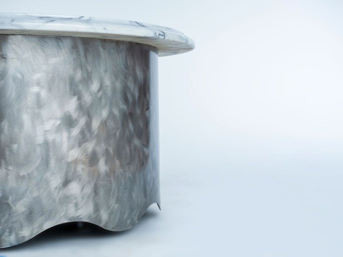 Marble-patterned side table on a light gray background