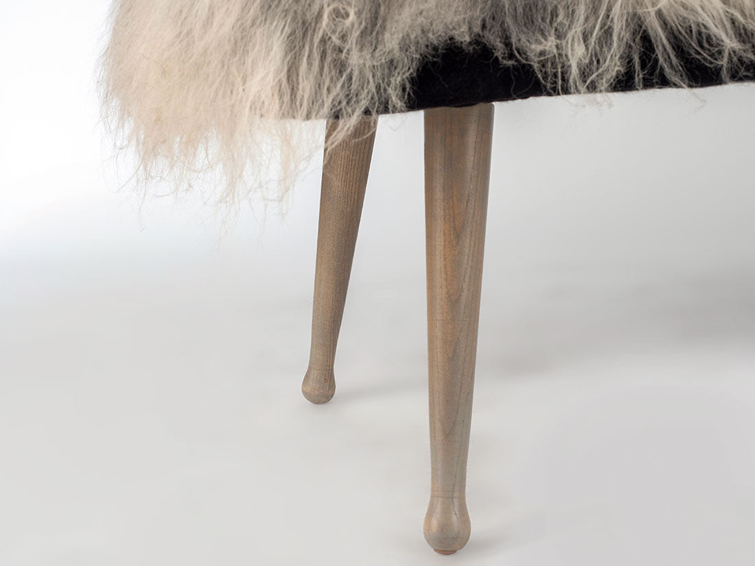 Furry chair with wooden legs on a white background