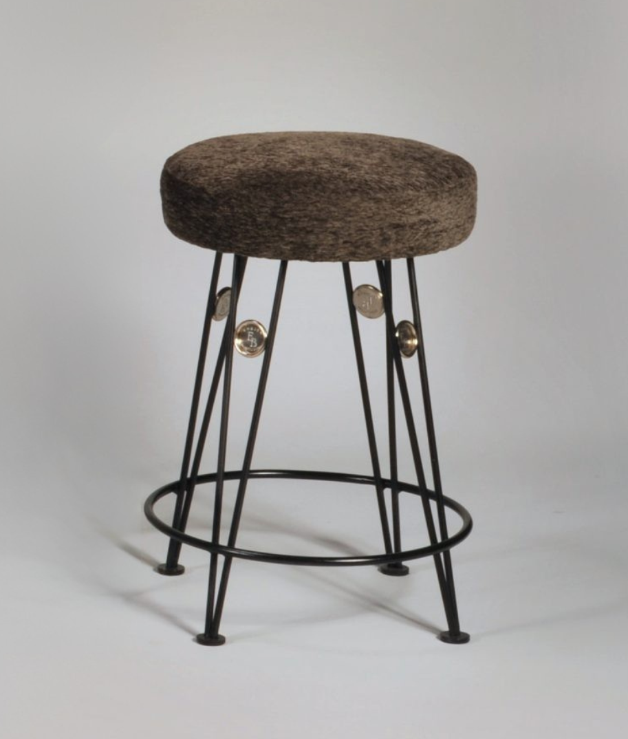 Bar stool with a brown cushioned seat and black metal legs on a light gray background