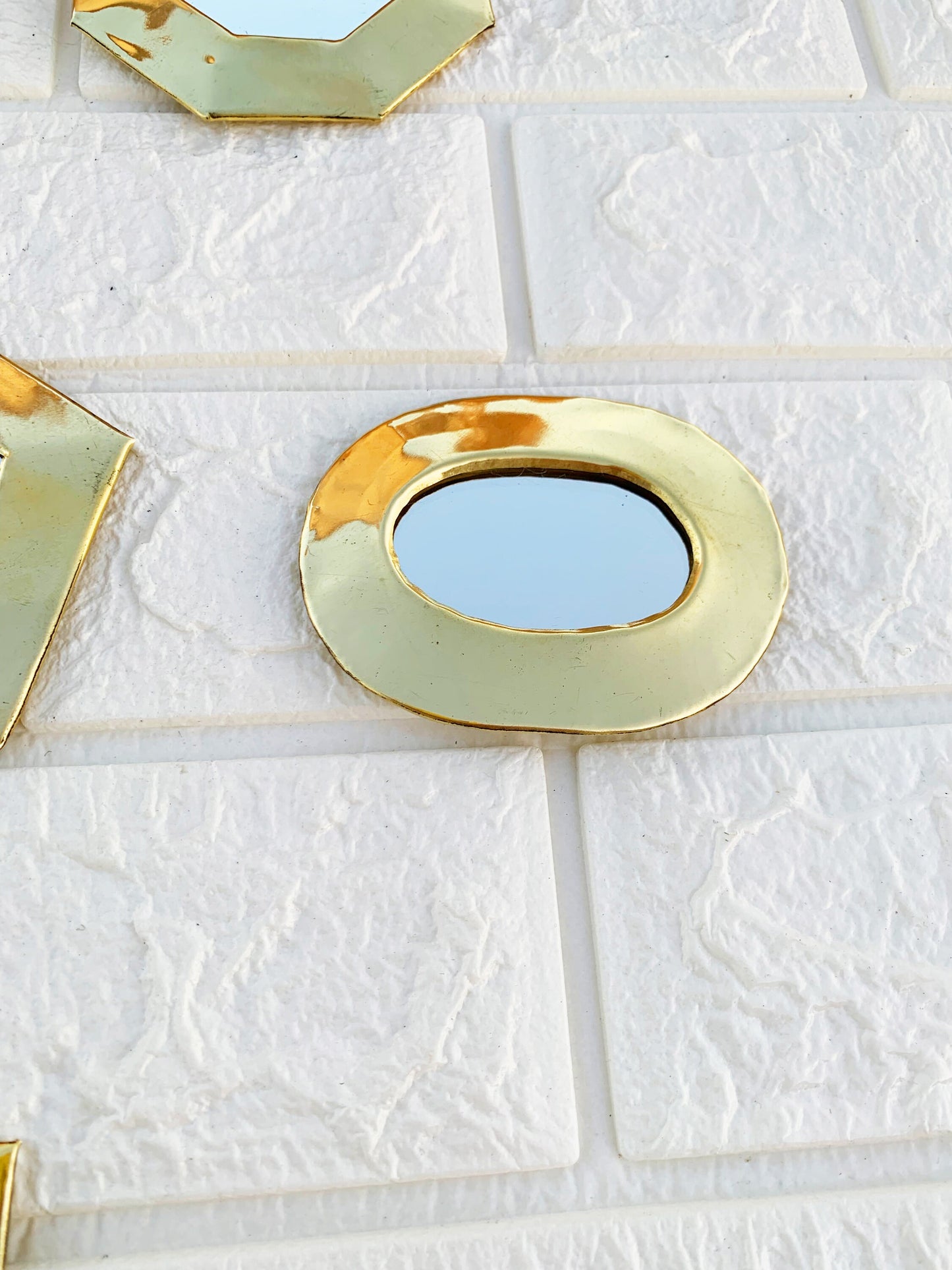a bathroom wall with a mirror and a tile floor