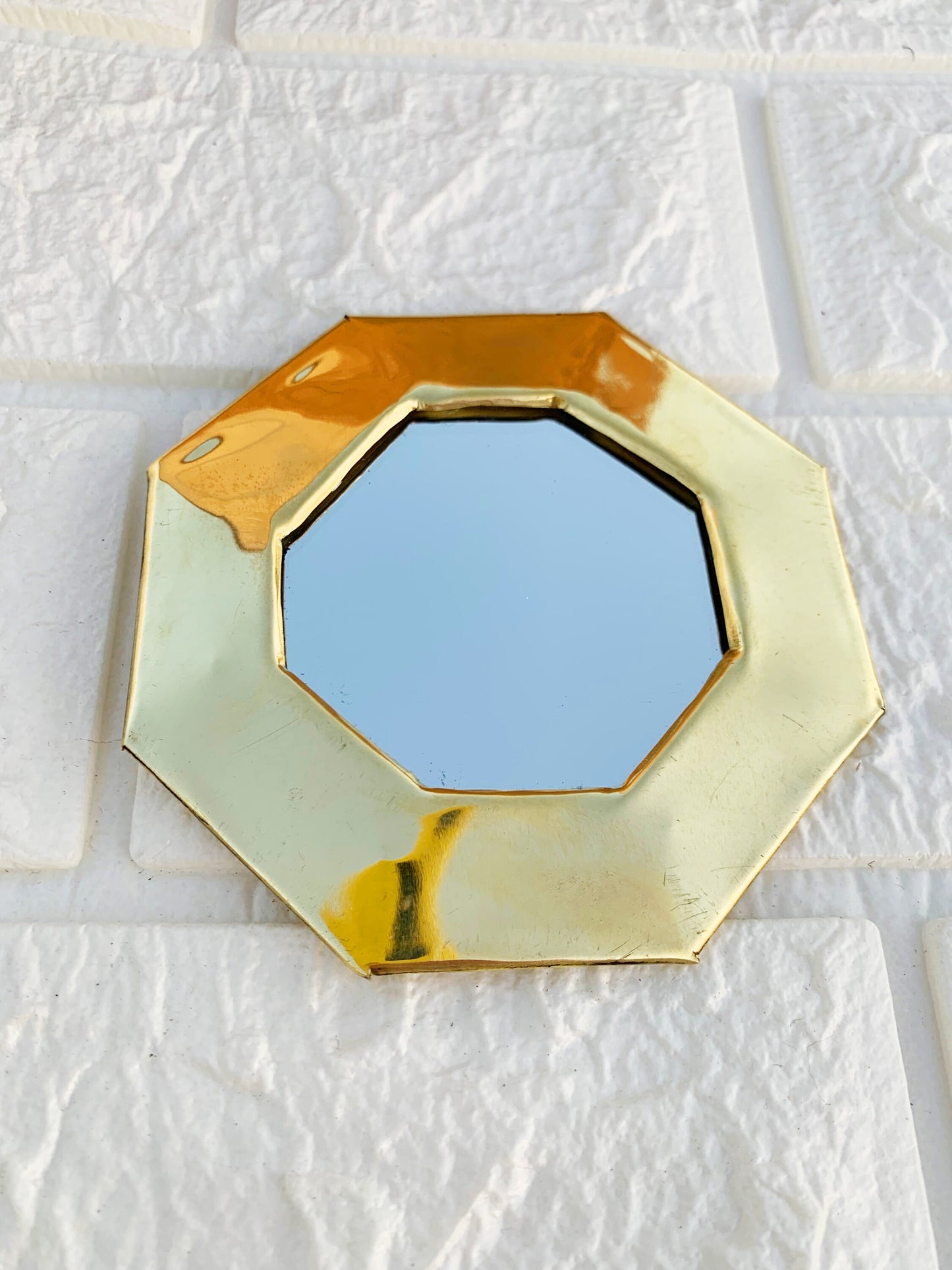 a mirror that is on the side of a wall