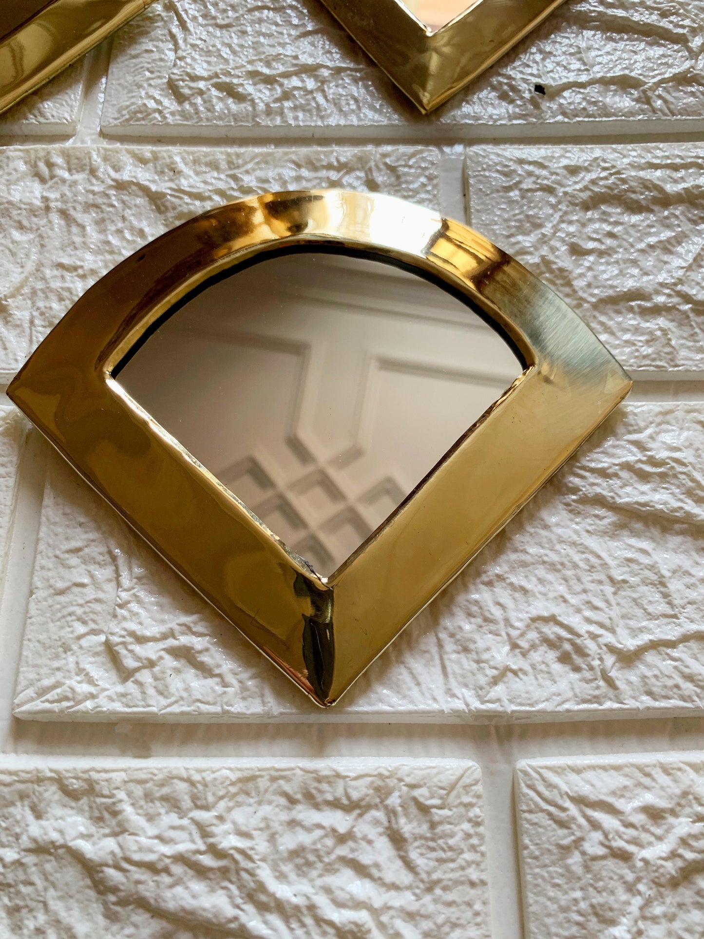 a mirror that is on the side of a wall