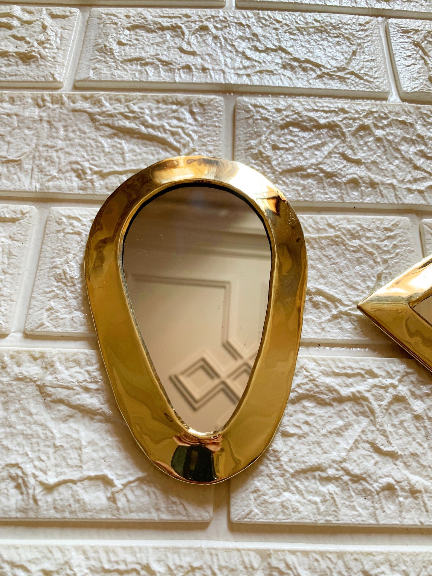 a mirror on a wall with a gold frame