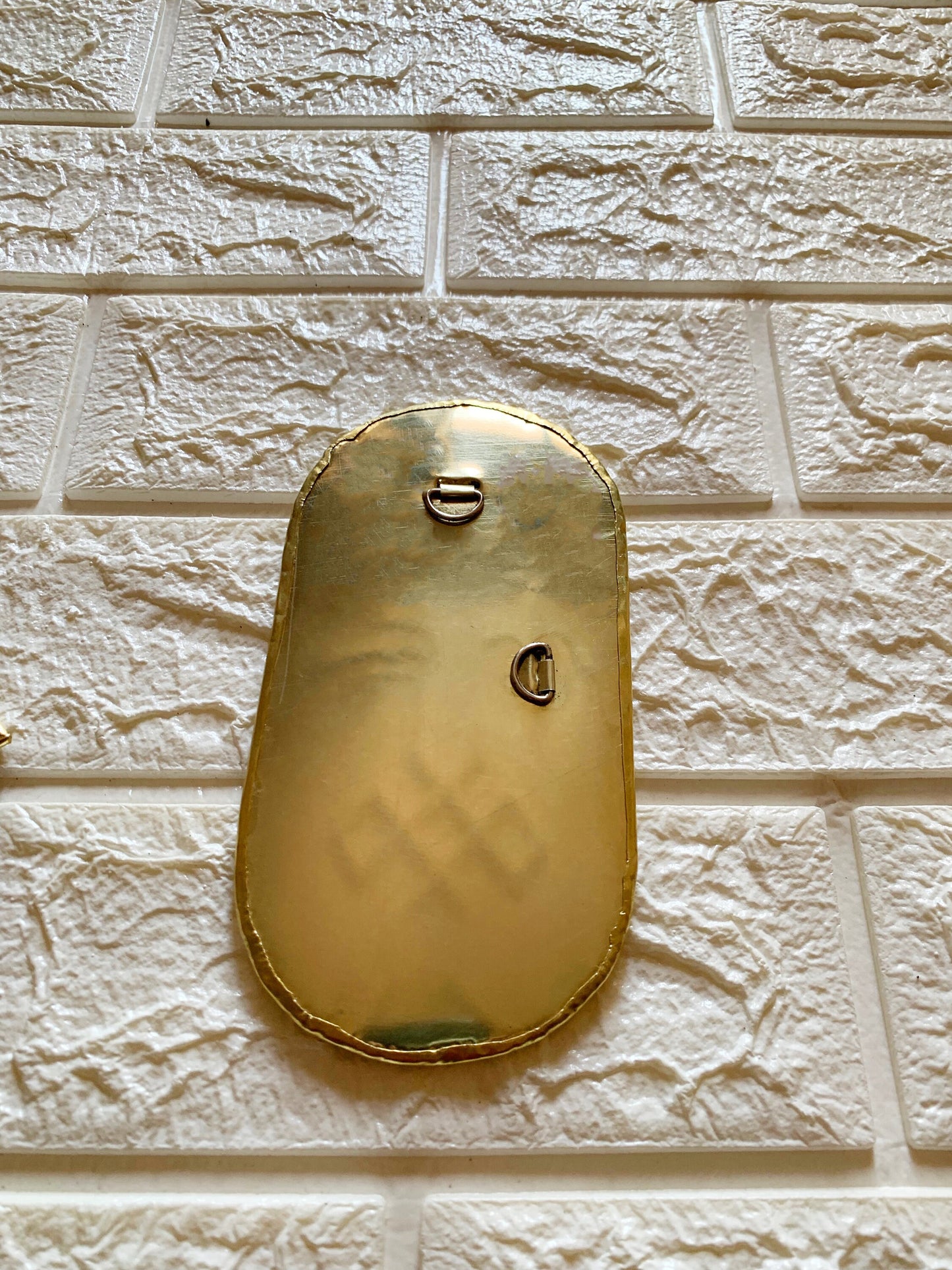 a close up of a clock on a brick wall