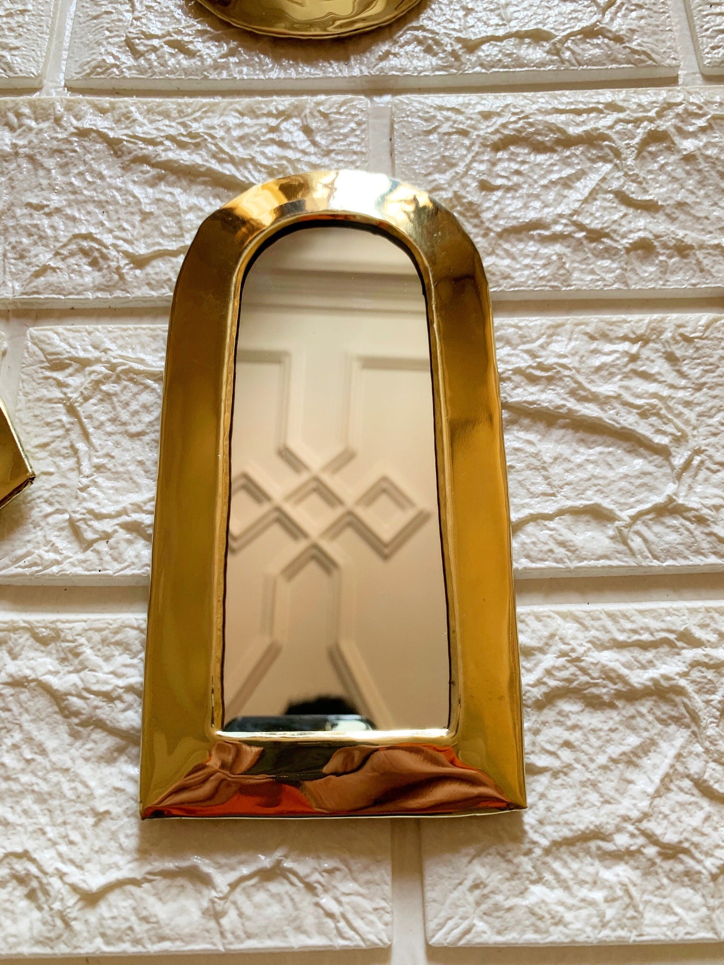 a mirror that is on the side of a wall