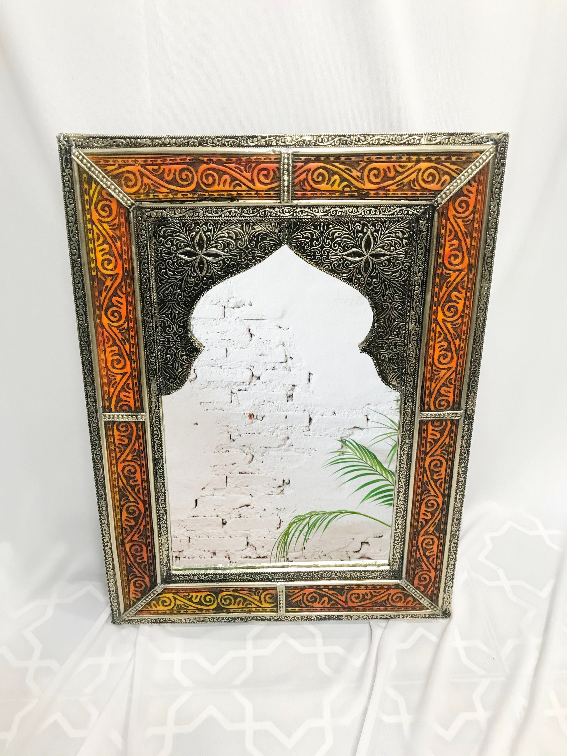 a mirror with a picture of a building on it