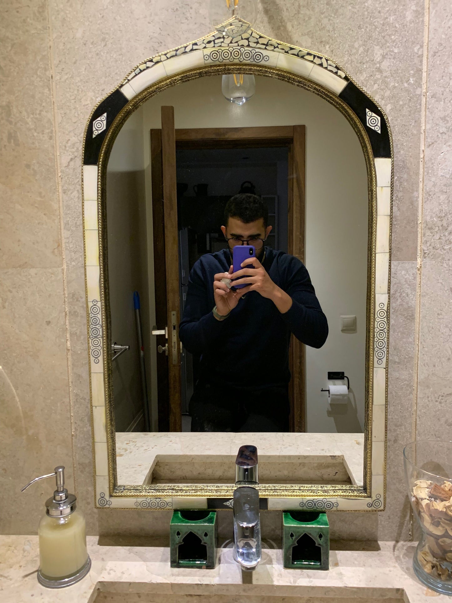 a man taking a picture of himself in a bathroom mirror