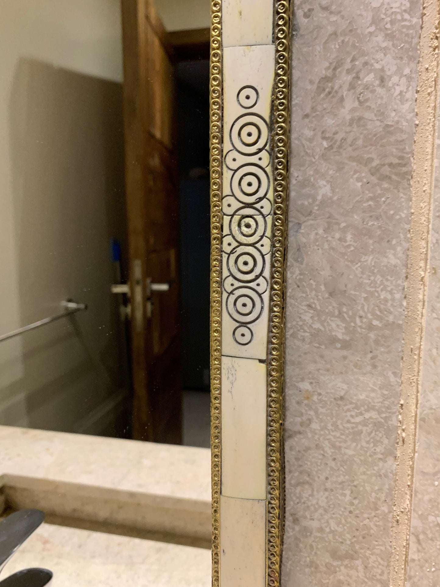 a mirror that is on the wall in a bathroom