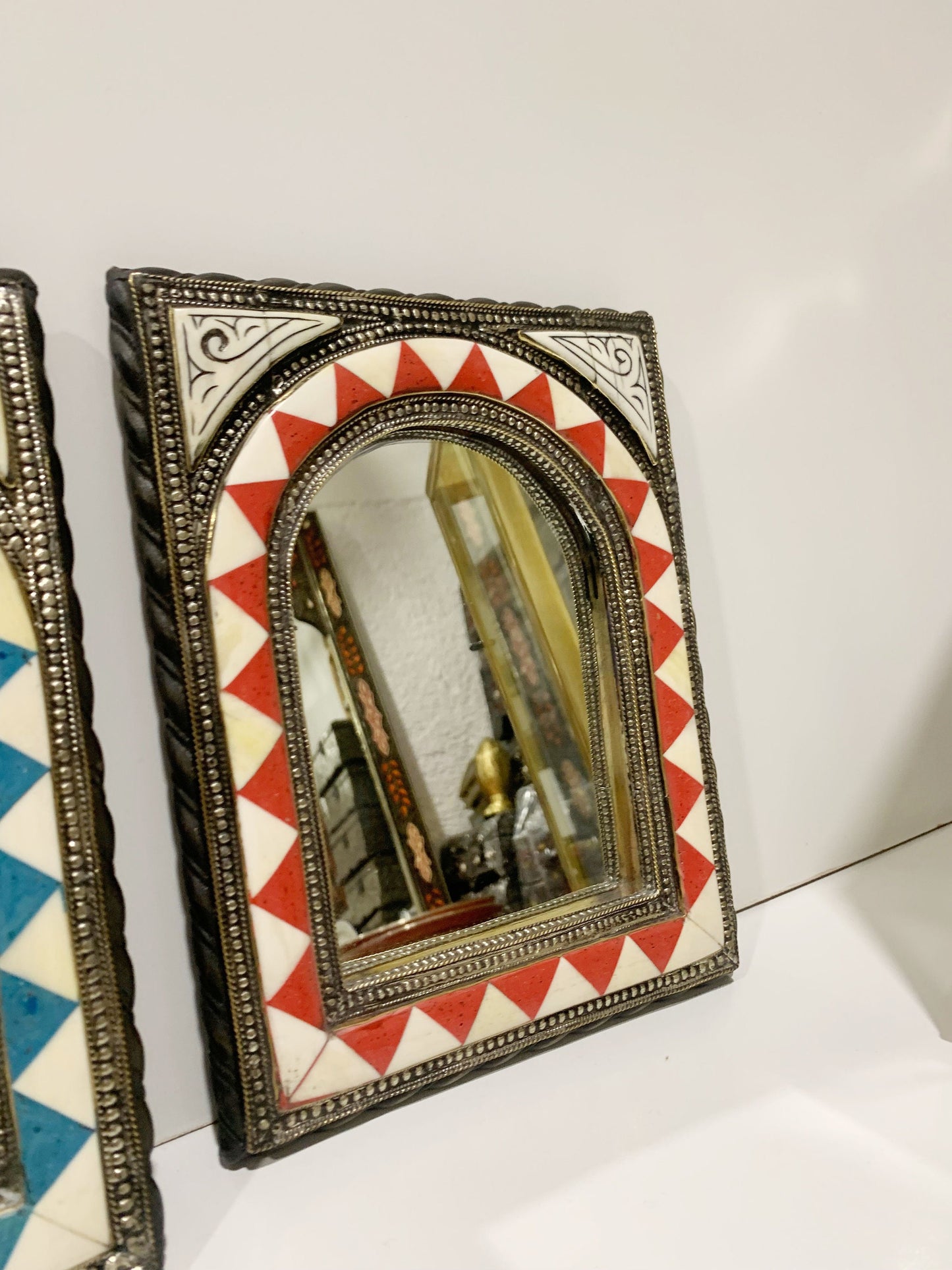 a mirror sitting on top of a white counter