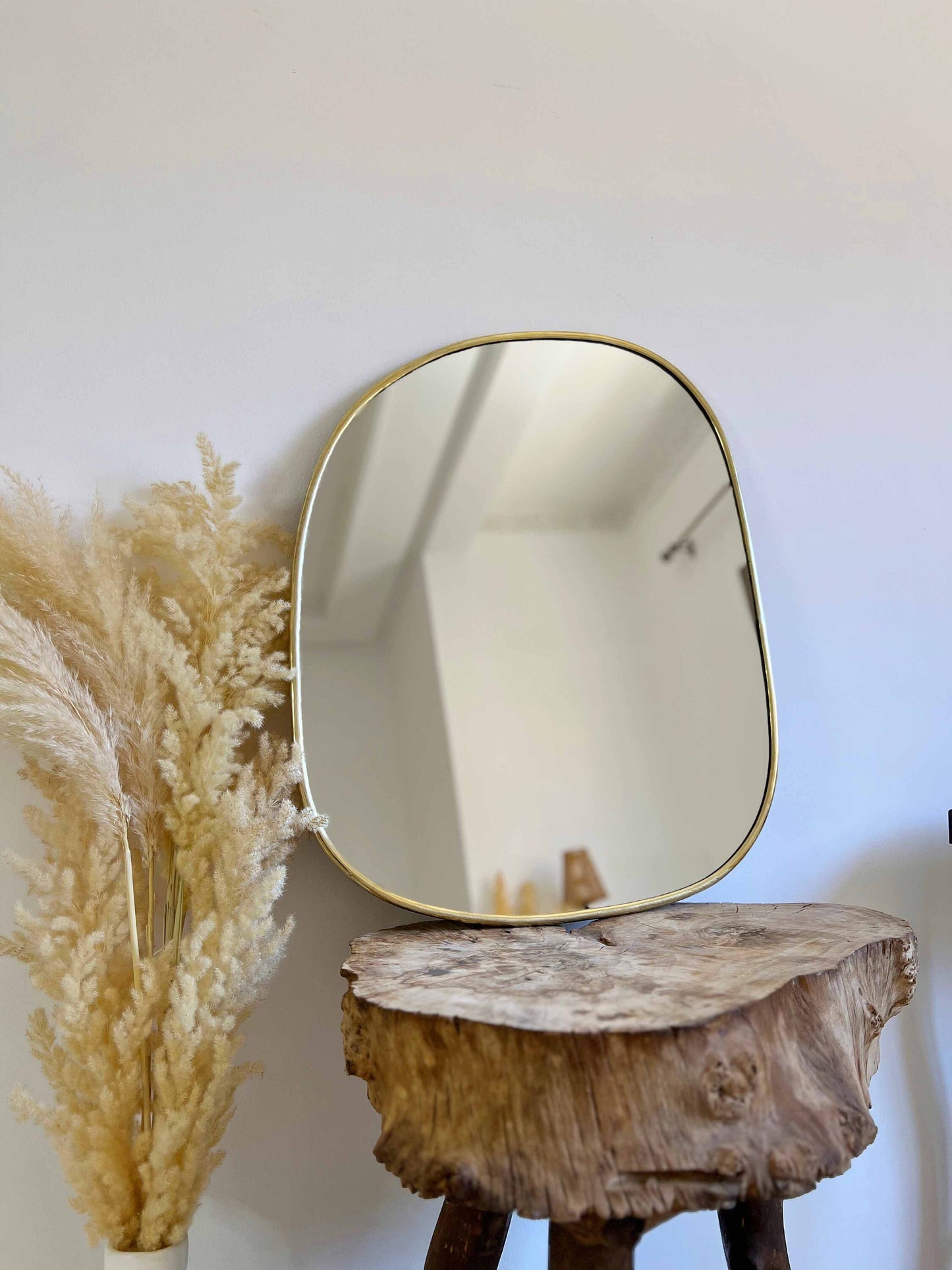 a mirror sitting on top of a wooden table