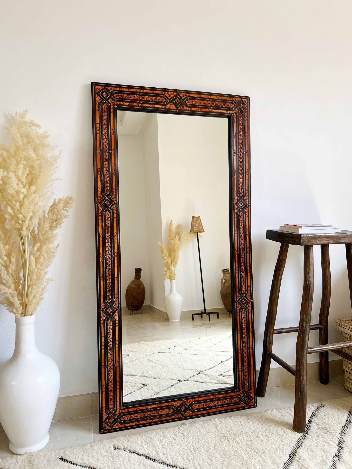 a large mirror sitting on top of a white rug