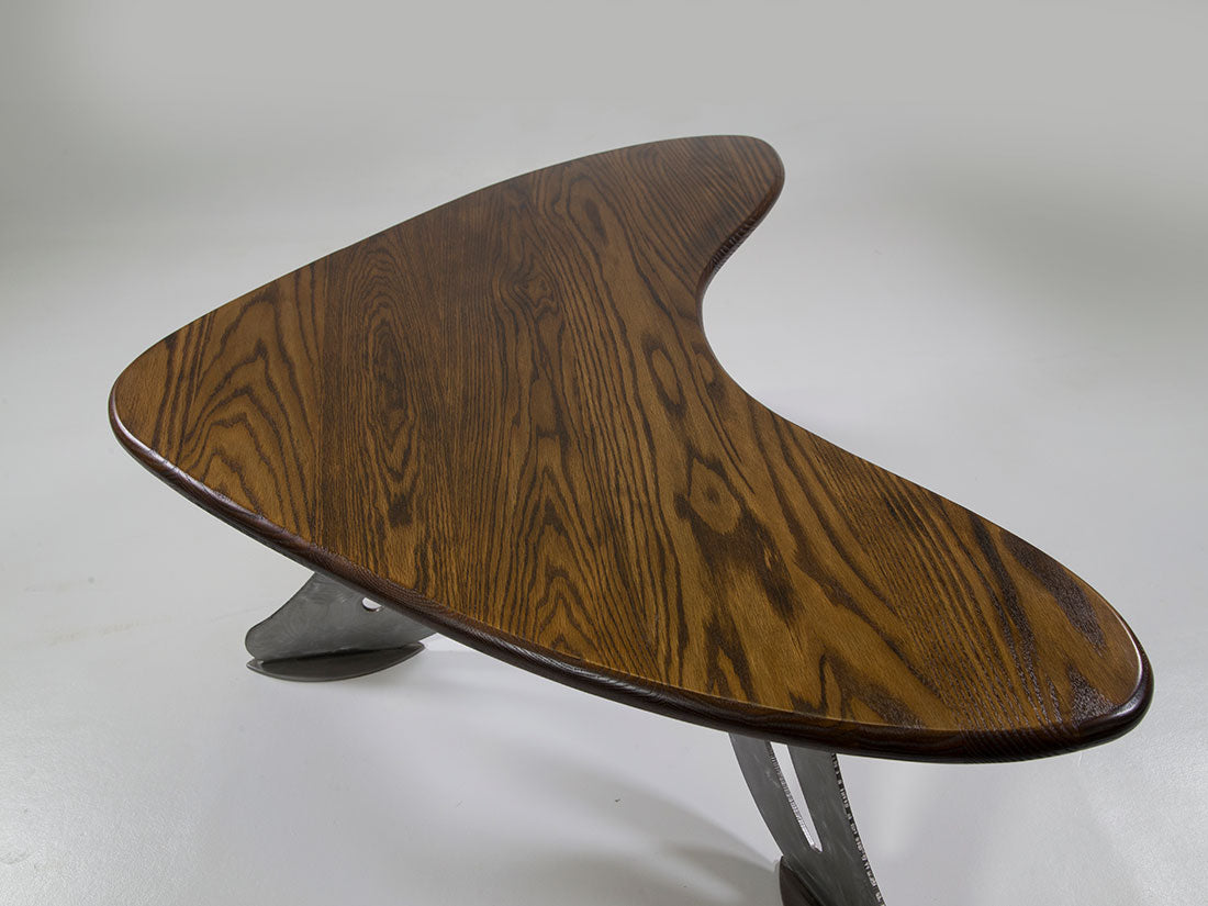 Wooden table with a unique design on a gray background