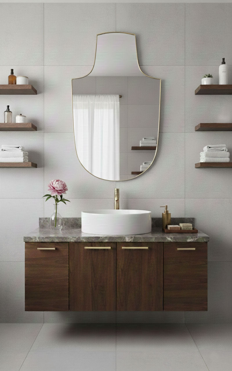 Arch-top shield brass mirror above modern bathroom vanity