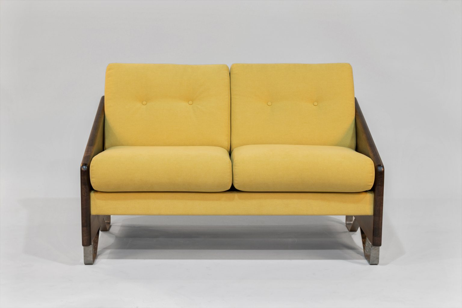 Yellow two-seater sofa with dark wooden frame on a white background