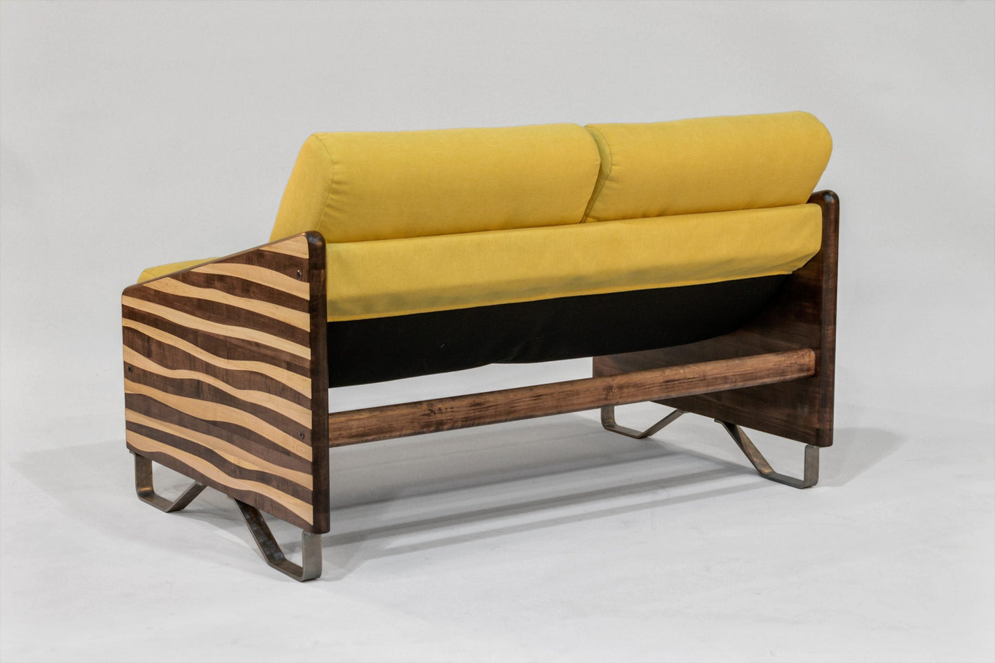 Sofa with yellow cushions and zebra-striped wooden frame on a white background