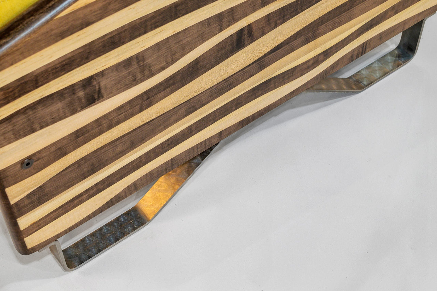 Wooden cutting board with metal handles on a white surface