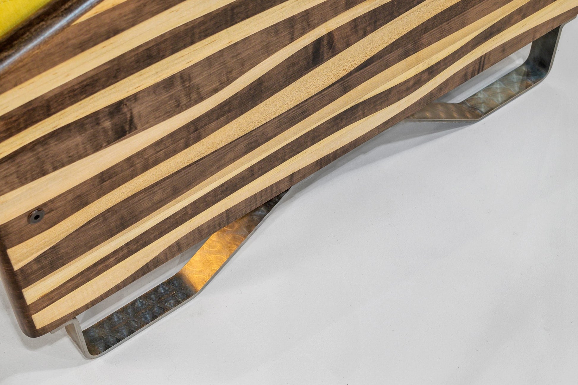 Wooden cutting board with metal handles on a white surface