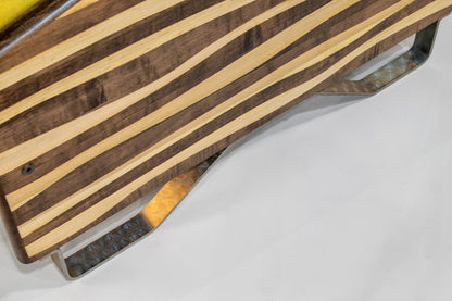 Wooden cutting board with metal handles on a white surface