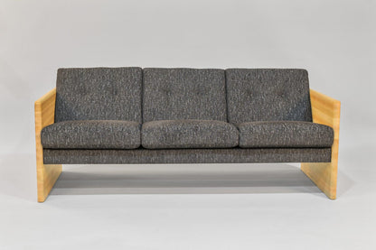 Gray sofa with wooden frame on a gray background
