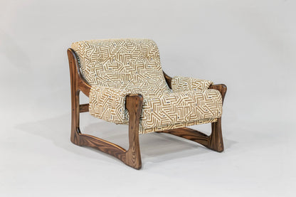 Wooden armchair with patterned fabric on a white background