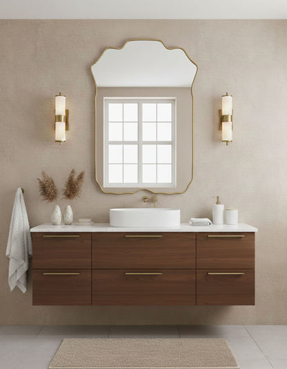 Soft crest rectangle brass mirror styled above modern bathroom vanity