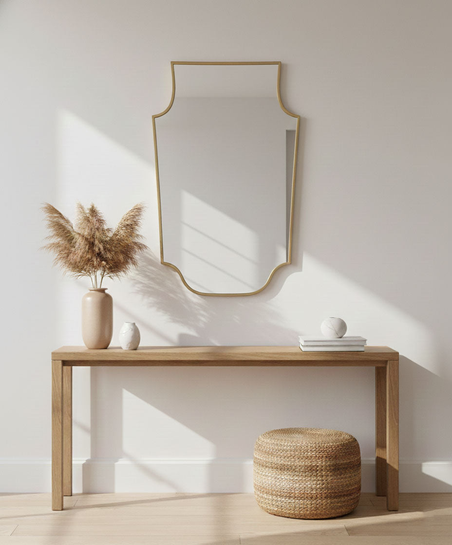 Decorative brass crest mirror on console table