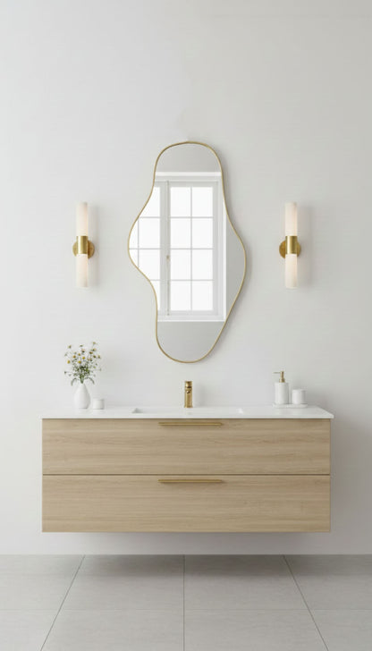 Waveform brass mirror above modern floating bathroom vanity