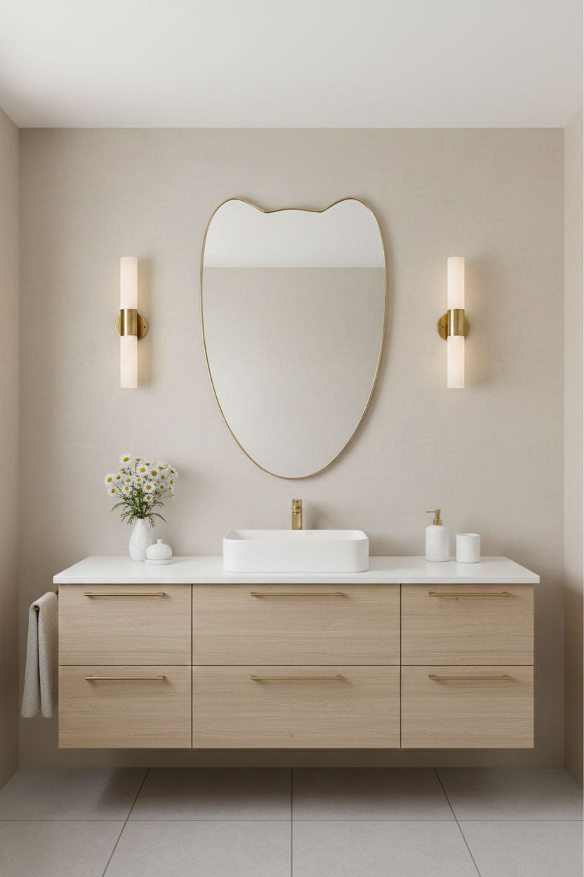 Bathroom vanity styled with Double-Petal Crest brass mirror and modern wall sconces