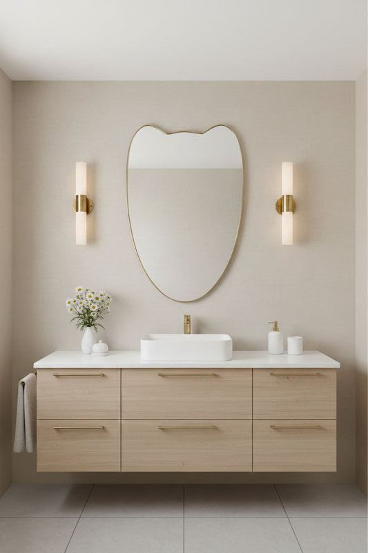 Bathroom vanity styled with Double-Petal Crest brass mirror and modern wall sconces