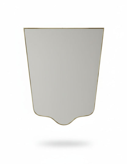 Minimal crest-edge brass mirror with tapered silhouette on white background
