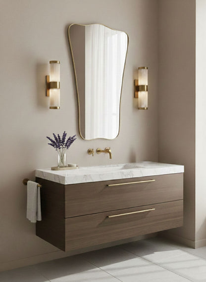 Butterfly wave mirror with organic brass frame above modern bathroom vanity