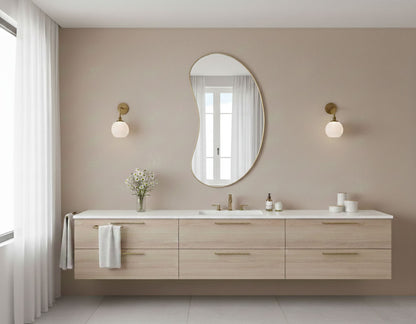 Bean curve brass mirror above modern floating bathroom vanity