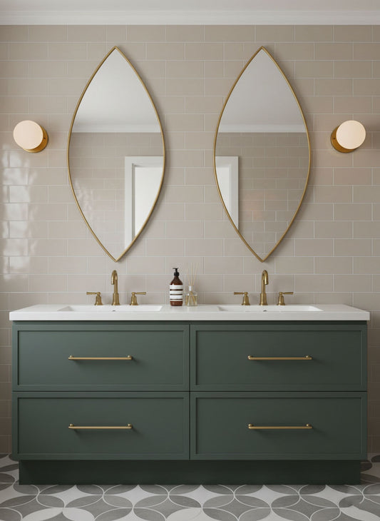 Leaf silhouette brass mirror above a double bathroom vanity