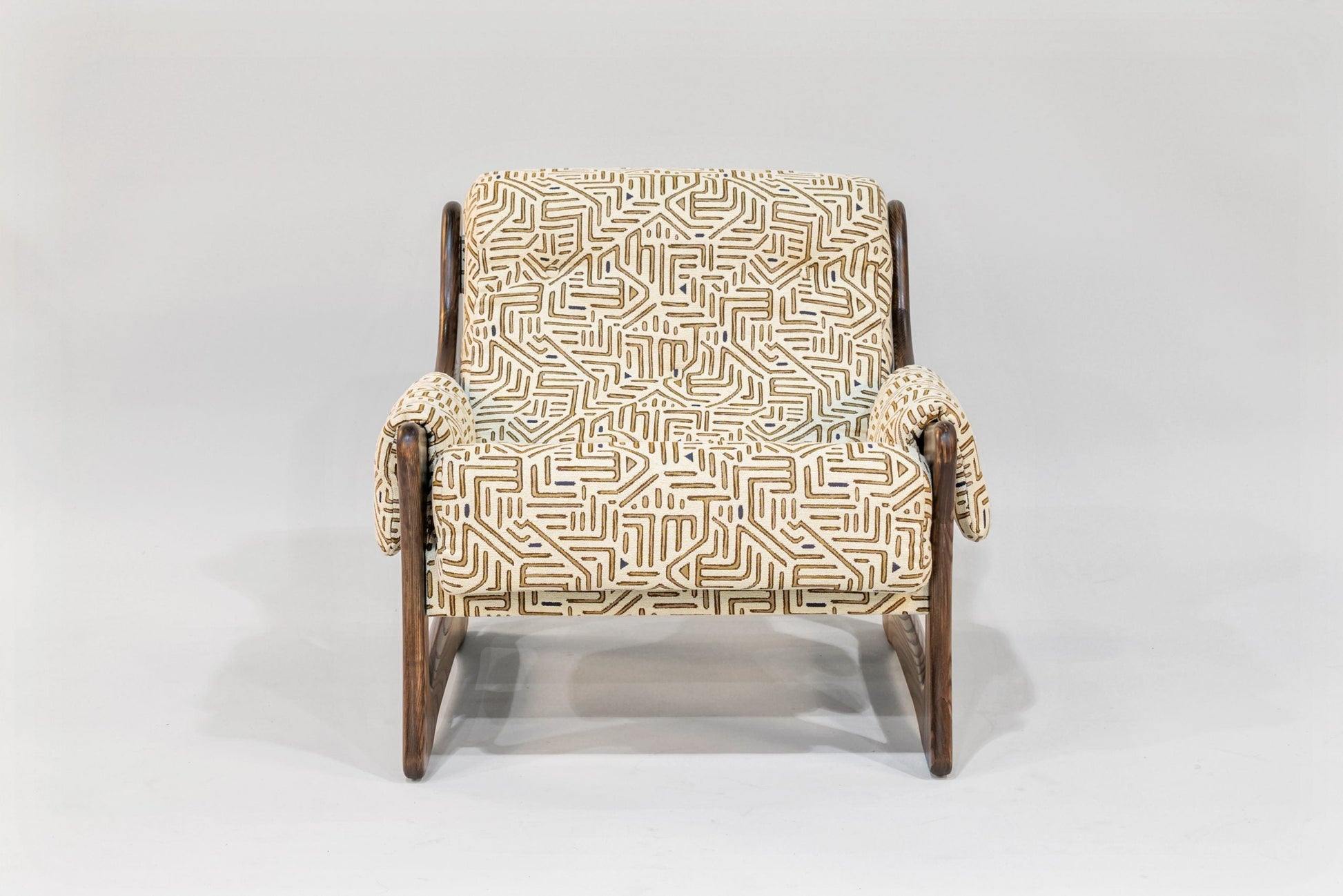 Chair with a patterned beige and brown cover on a white background