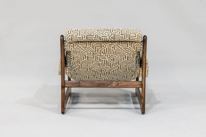 Chair with geometric patterned cushion on a white background