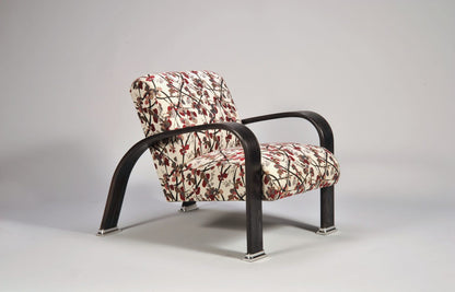 Patterned armchair with black metal frame on a gray background