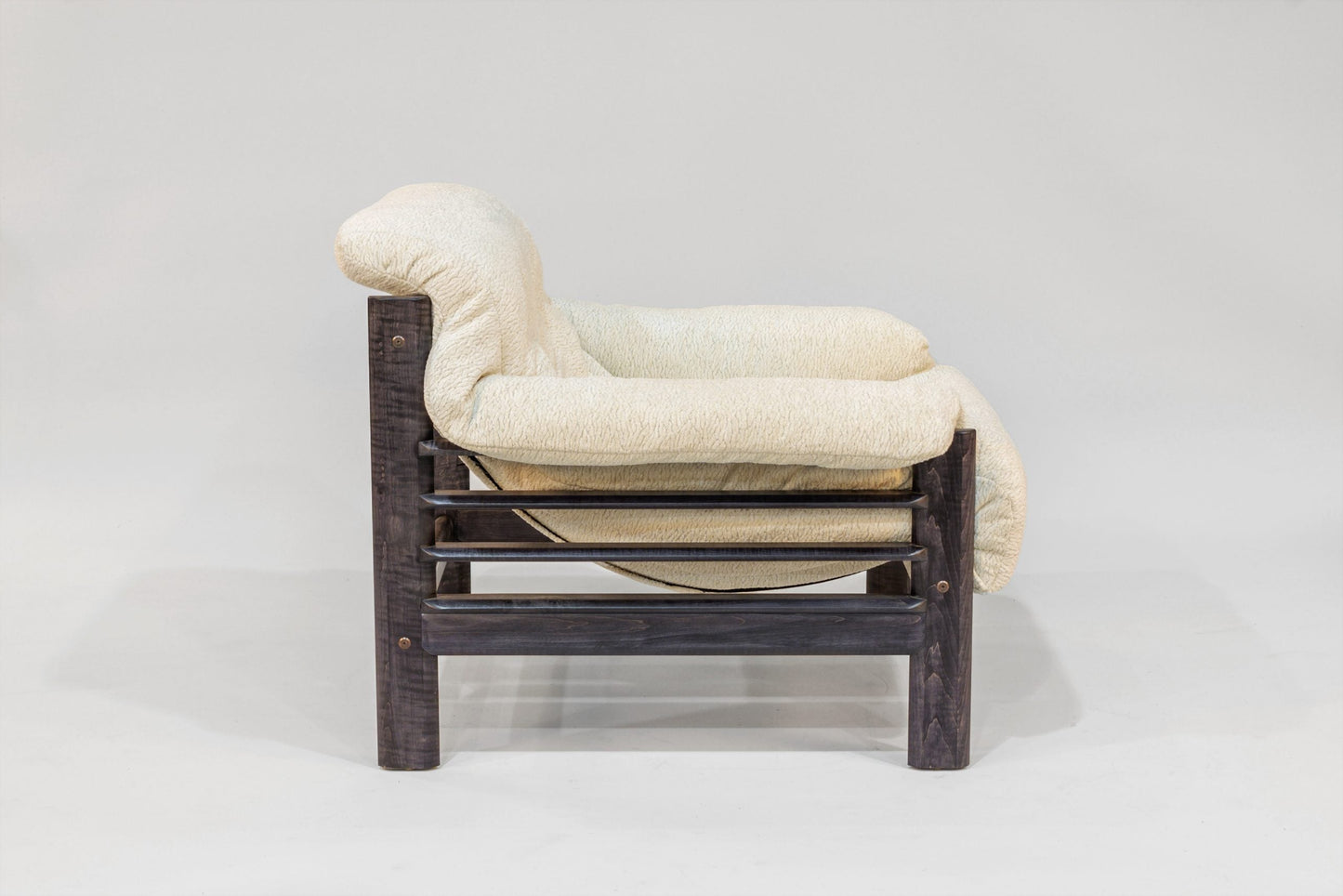 Chair with a wooden frame and white cushion on a white background