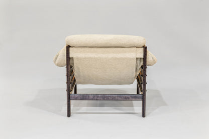 Beige lounge chair with wicker frame on a white background