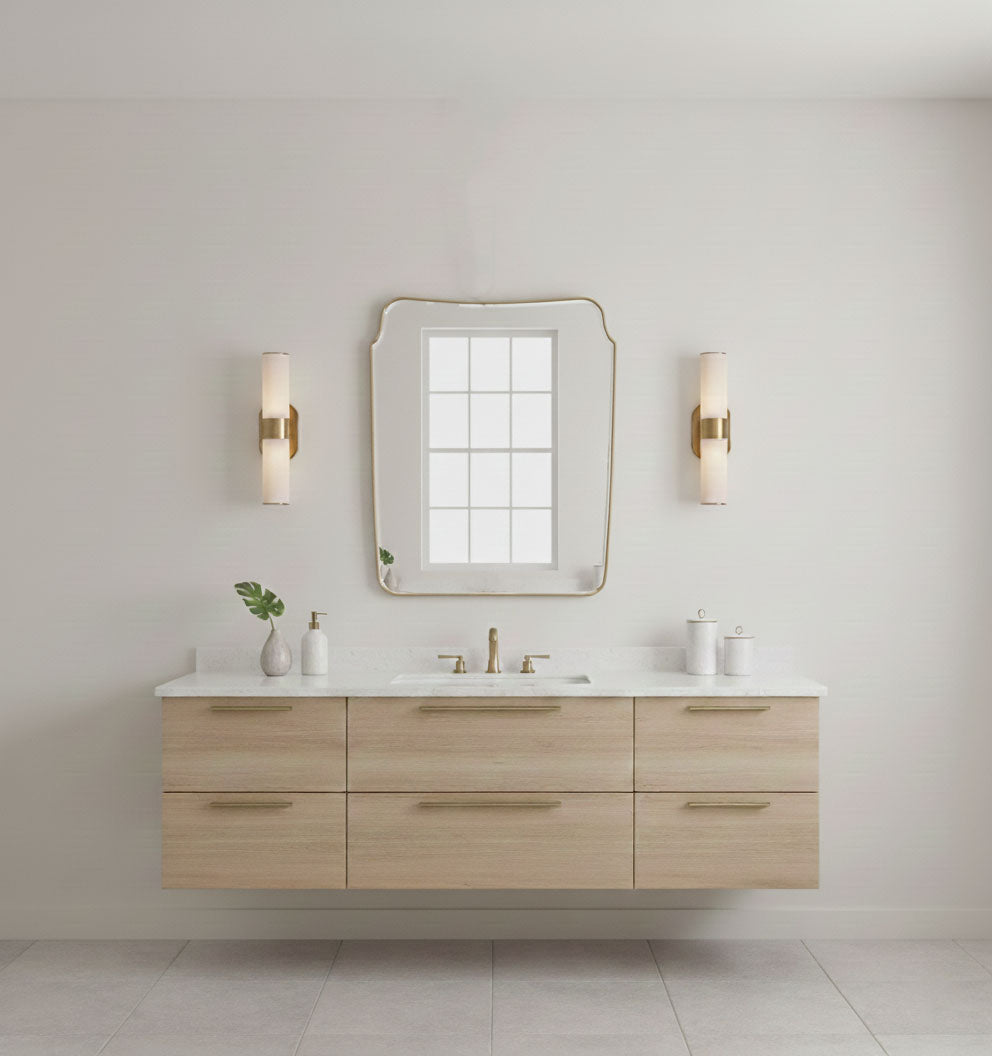 Rounded crest rectangle brass mirror mounted above a modern bathroom vanity