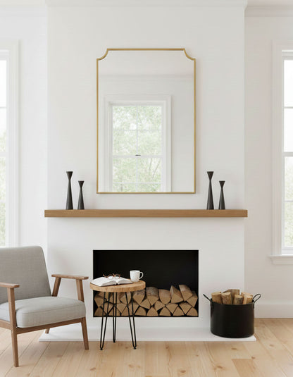 Chateau style rectangle brass mirror styled above fireplace mantel