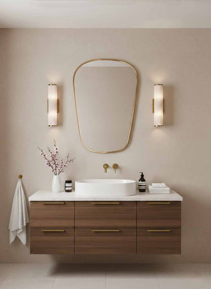  brass bathroom mirror above modern wood vanity
