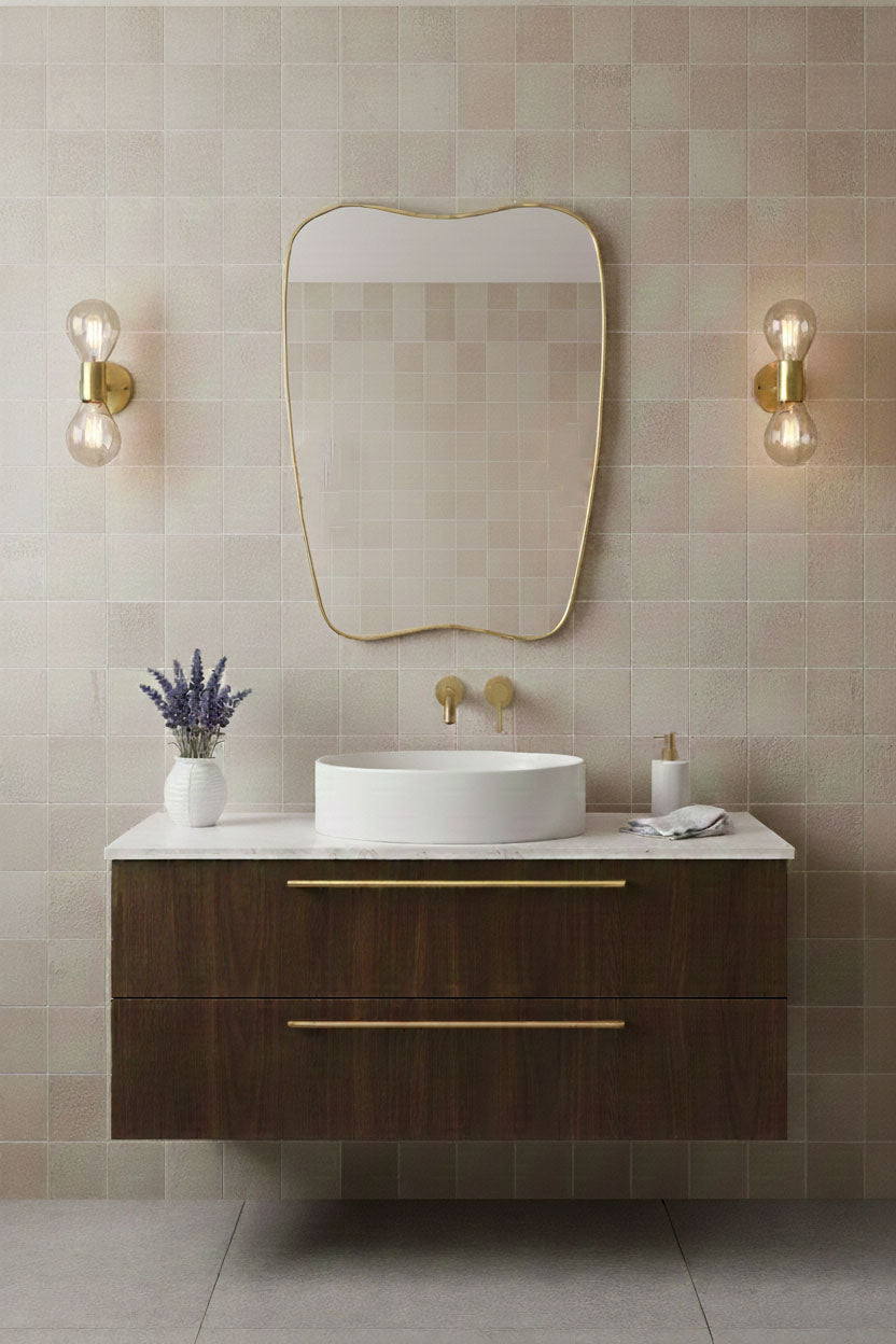 Modern soft-crest brass mirror styled with tiled bathroom wall
