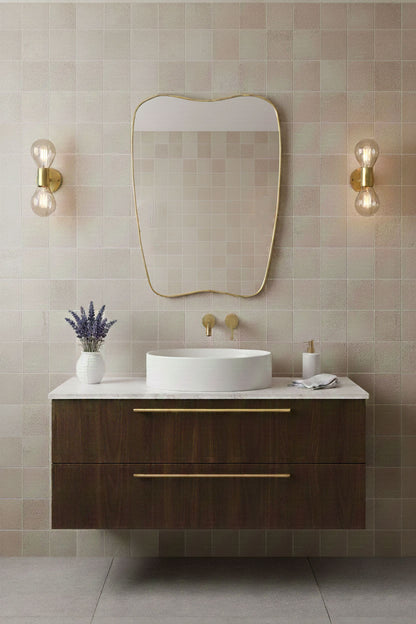 Modern soft-crest brass mirror styled with tiled bathroom wall