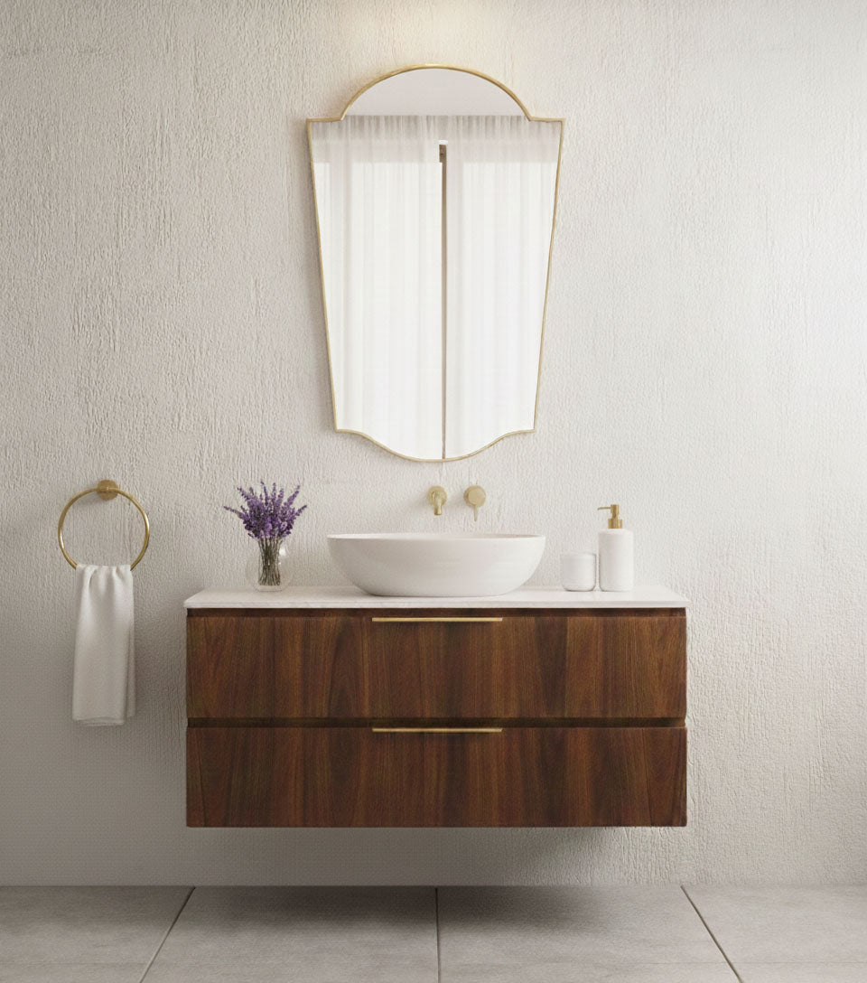 Handmade rounded crest mirror with brass frame over wooden vanity