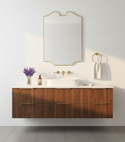 Scalloped twin-curve brass mirror in warm neutral bathroom