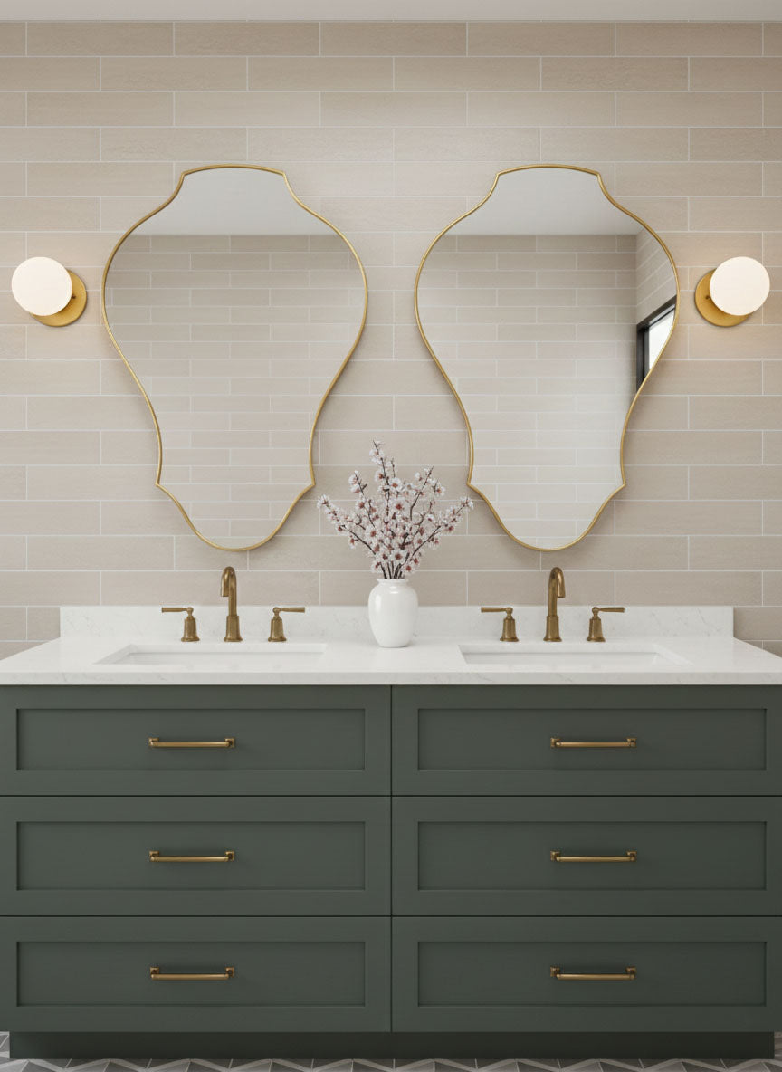 Pair of tulip shield brass mirrors above double bathroom vanity