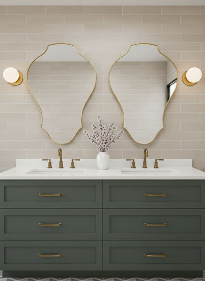 Pair of tulip shield brass mirrors above double bathroom vanity